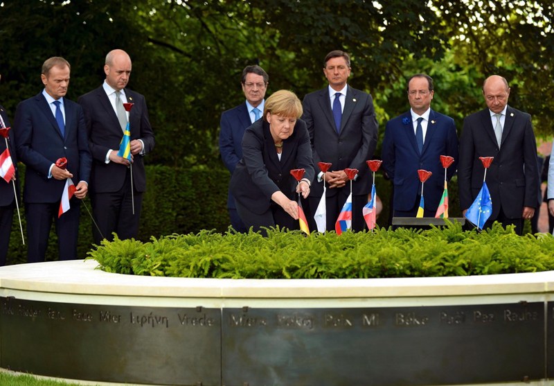 German Chancellor Angela Merkel plants a porcelain flower on the 'Peace Bench' to commemorate the 100th anniversary of World War I, in Ypres city of Belgium,June 26,2014. European Union leaders gather on Thursday to mark the centenary of World War I and hold talks on future EU policy. (Photo by Dursun Aydemir/Anadolu Agency/Getty Images).