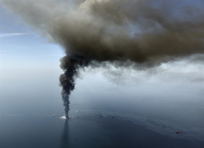 FILE - This aerial April 21,2010 file photo, taken in the Gulf of Mexico, more than 50 miles southeast of Venice on Louisiana's tip, shows an oil slick is seen as the Deepwater Horizon oil rig burns.