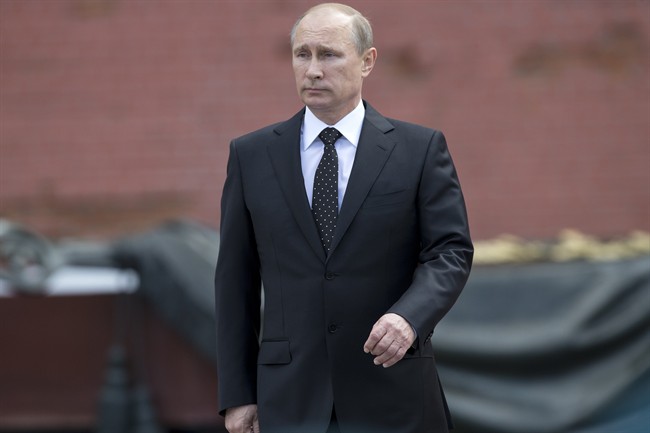 In this photo taken on Sunday, June 22, 2014, Russian Vladimir Putin takes part in a wreath laying ceremony at the Tomb of the Unknown Soldier outside Moscow's Kremlin Wall, in Moscow, Russia, to mark the 73rd anniversary of the Nazi invasion of the Soviet Union.
