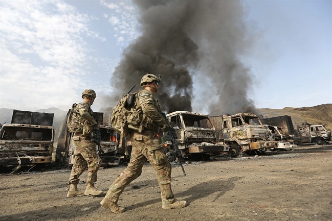 U.S. soldiers investigate the scene of an suicide attack in the Torkham, Nangarhar province, Afghanistan, Thursday, June 19, 2014. On Sept. 28, 2016, an Afghan official confirmed 13 civilians were killed in an airstrike on a residential house in the same province.