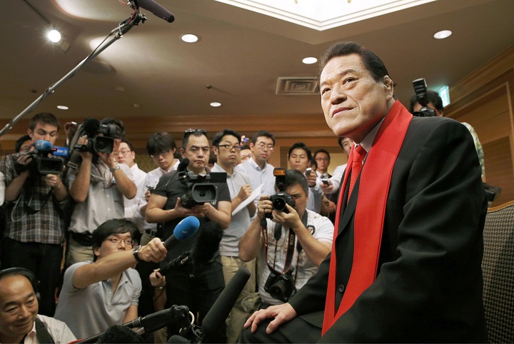In this Sunday, July 7, 2014 photo, Kanji "Antonio" Inoki, pro wrestling legend turned politician, is surrounded by journalits during a press conference in Tokyo. Inoki is planning to entertain the North Korean capital with a martial arts extravaganza next month - and hopefully meet some senior leaders while he is there. Inoki was to leave for Pyongyang on Wednesday, July 9 to set the final details for the Aug. 30-31 event, which organizers say will feature pro wrestling, taekwondo, the Japanese martial art aikido and a traditional Korean style of wrestling.