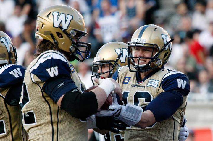 Robert Marve (16) of the Winnipeg Blue Bombers celebrates a touchdown with teammate Steve Morley during their game against the Montreal Alouettes on Friday in Montreal.