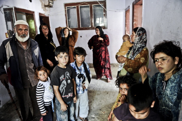 Syrian refugees pose in a disused house on June 28, 2014 in the Fikirtepe area of Istanbul. 