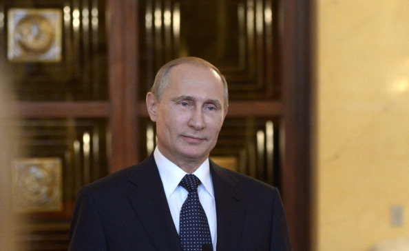 Russia's President Vladimir Putin smiles while speaking with journalists in Itamaraty Palace in Brazilia, early on July 17, 2014. The United States and Europe strengthened sanctions on Moscow over Ukraine yesterday, with President Barack Obama taking his first direct swipes in the finance, military and energy sectors of the Russian economy.