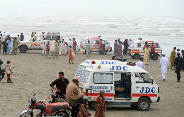 Ambulances are pictured at the beachfront during ongoing recovery operations in search of missing bathers, feared drowned, at Clifton beach in Karachi on July 31, 2014. At least 19 bathers have drowned and four are missing in rough seas off Pakistan's biggest city Karachi, officials said, after defying a ban on swimming during the monsoon season.  The bathers were among thousands who had taken to the beaches to celebrate the Eid holiday, which began on Tuesday and continues until Friday.