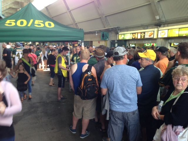Football fans line up to buy 50/50 tickets at the Edmonton Eskimos game Thursday, July 24, 2014.