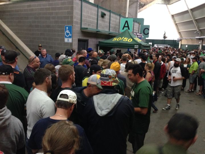 Football fans line up to buy 50/50 tickets at the Edmonton Eskimos game Thursday, July 24, 2014.
