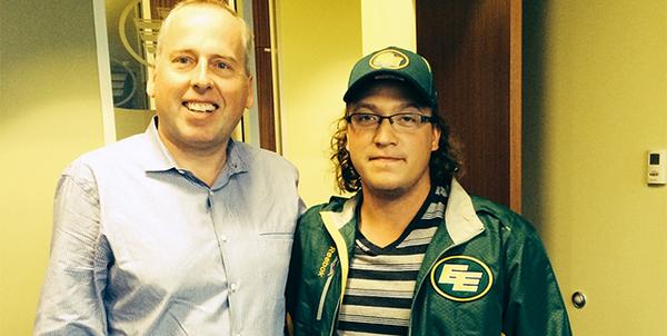 Edmonton Eskimos President & CEO Len Rhodes posing with 20-year-old Connor Croken, winner of the record $348,534 50/50 jackpot.Friday, July 25, 2014.