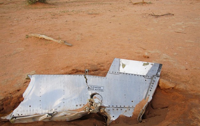 This photo provided on Friday, July 25, 2014, by the Burkina Faso Military shows a part of the Air Algerie plane at the crash site, in Mali. 