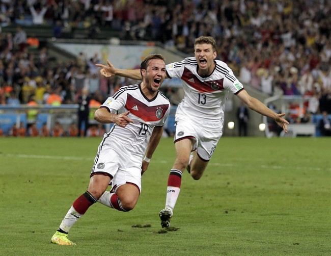 Germany's Mario Goetze (19) celebrates with Thomas Mueller after scoring his side's first goal in extra time.