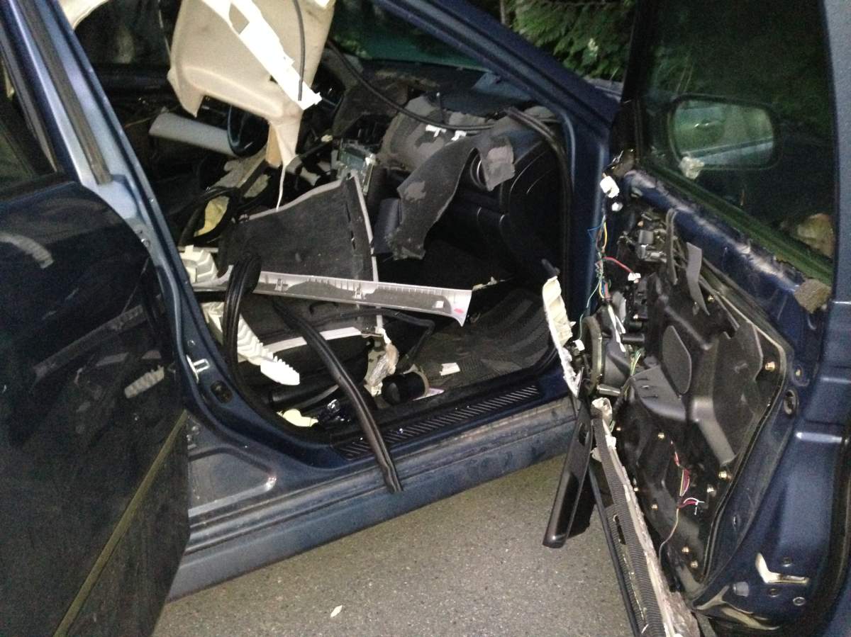 The damage the bear did to the car.