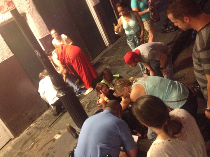 This photo released by David Minsky shows victims being assisted moments after a shooting on Bourbon Street early Sunday, June 29, 2014. 