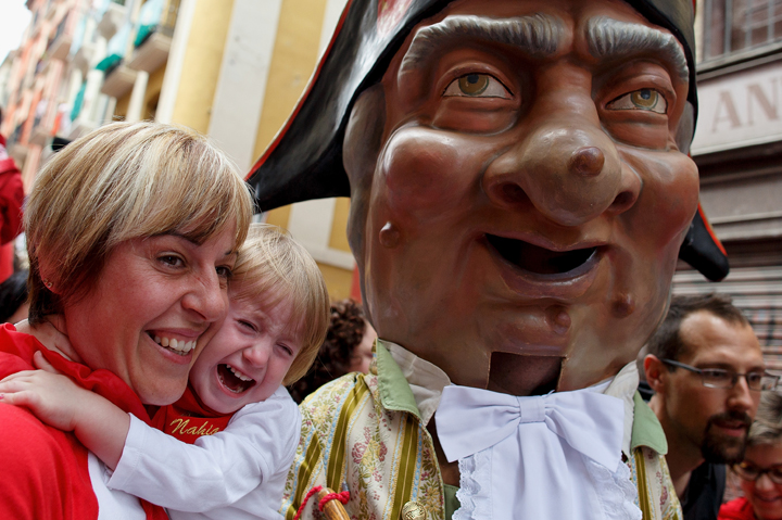 A girl cries as a kiliki approaches to her during the Comparsa de Gigantes y Cabezudos ‘Giants and Big Heads parade’ during the second day of the San Fermin Running Of The Bulls festival on July 7, 2014 in Pamplona, Spain.