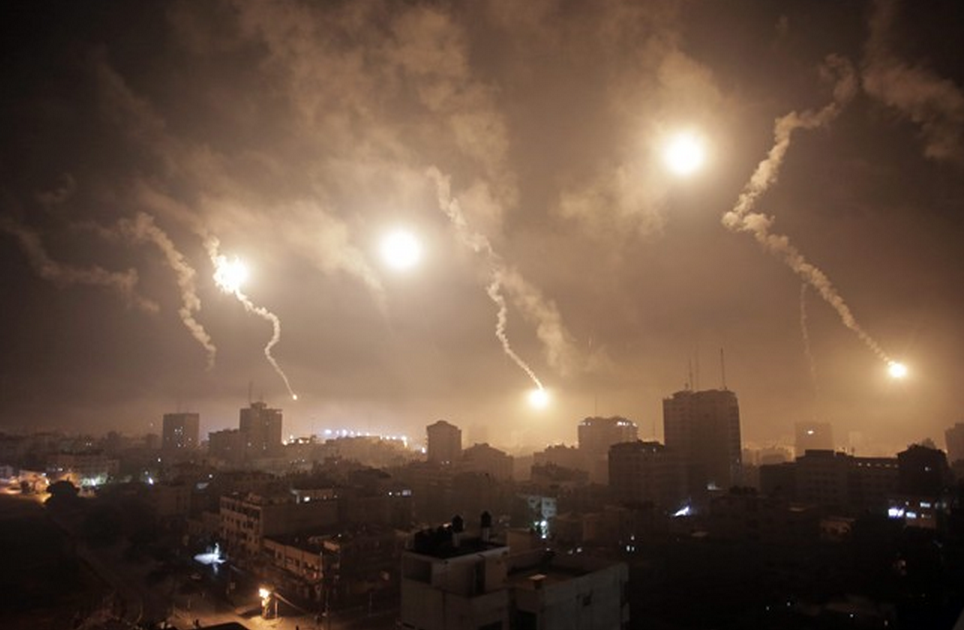Israeli forces' flares light up the night sky of Gaza City on early Tuesday, July 29, 2014. A truce between Israel and Hamas militants in Gaza remained elusive as diplomats sought to end the fighting at the start of the Eid al-Fitr holiday, marking the end of the Muslim holy month of Ramadan. (AP Photo/Khalil Hamra).