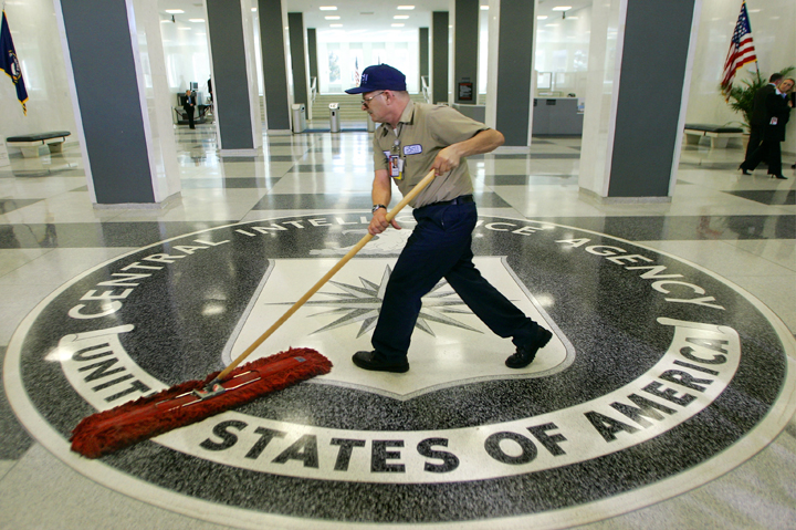 A workman quickly slides a dustmop over the floor at the Central Intelligence Agency headquarters in Langley, Va., near Washington.  