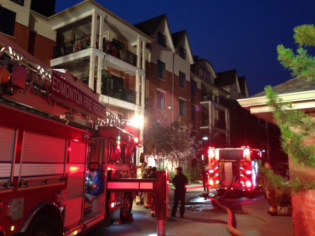 Fire crews battle a fire in a Edmonton condo building, Thursday, July 17, 2014. 