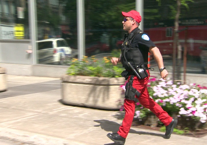 Montreal police officers wear red caps and dress down in protest over pension plan changes.
