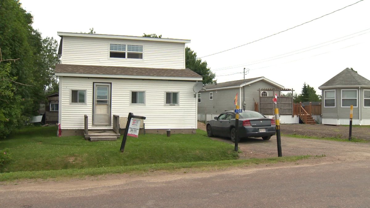 A for sale sign sits in front of Karla Arsenault's home in Pointe-Du-Chene, NB on Friday, July 11.