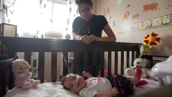 Josie Ledoux spends some time with her granddaughter Aurora in her deceased daughter's old bedroom in Prince Albert, Sask. on Saturday, July 12,2014. Ledoux's daughter Brandi Lepine was killed by an alleged drunk driver a year ago while pregnant with Aurora.