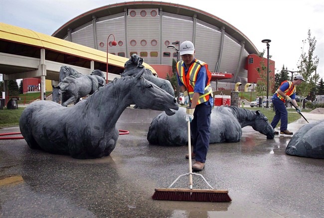 Clean-up crews work at getting the Calgary Stampede grounds ready in Calgary, Alta., Monday, June 24, 2013. 