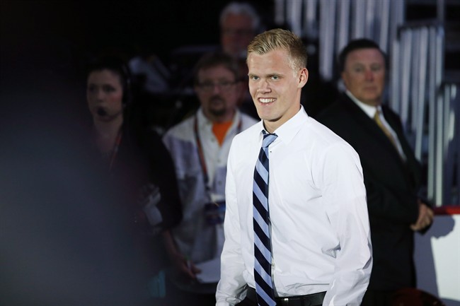 Nikolaj Ehlers walks to the stage after being chosen ninth overall by the Winnipeg Jets during the first round of the NHL hockey draft on June 27 in Philadelphia.