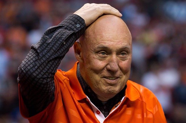 Former B.C. Lions head coach Don Matthews rubs his head after taking off his hat while being inducted into the CFL football team\’s Wall of Fame during halftime of the team\’s game against the Edmonton Eskimos in Vancouver, B.C., on Saturday July 20, 2013. The Montreal Alouettes are bringing back Matthews and adding Turk Schonert as consultants to their coaching staff. THE CANADIAN PRESS/Darryl Dyck