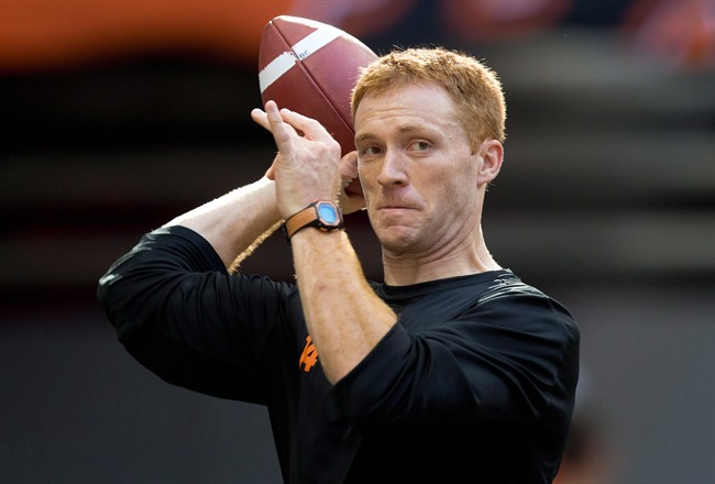 B.C. Lions quarterback Travis Lulay passes as his teammates warm up before a CFL football game against the Winnipeg Blue Bombers in Vancouver, B.C., on Friday July 25, 2014.