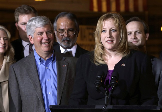 Lisa Raitt speaks as Michigan Gov. Rick Snyder, left, listens during the announcement the United States State Department issued a key permit to build a second bridge linking the United States and Canada from Detroit to Windsor, Ontario during a news conference in Detroit. in Detroit, Friday April 12, 2013.