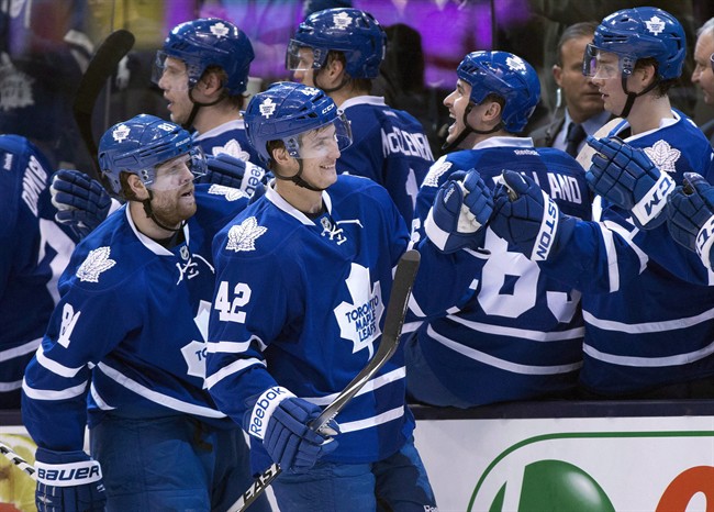 Toronto Maple Leafs Tyler Bozak (42) is congratulated on his goal along with teammate Phil Kessel (left) for the assist against the Boston Bruins during first period NHL action in Toronto on Thursday April 3, 2014.