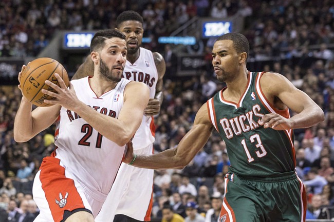 Toronto Raptors' Greivis Vasquez (left) drives towards Milwaukee Bucks' Ramon Sessions during second half NBA basketball action in Toronto on April 14, 2014. Guard Greivis Vasquez has reportedly re-signed with the Toronto Raptors. THE CANADIAN PRESS/Chris Young.