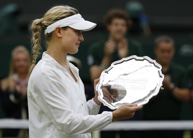 Eugenie Bouchard holds her runner-up trophy at the All England Lawn Tennis Championships in Wimbledon, Saturday, July 5, 2014. 