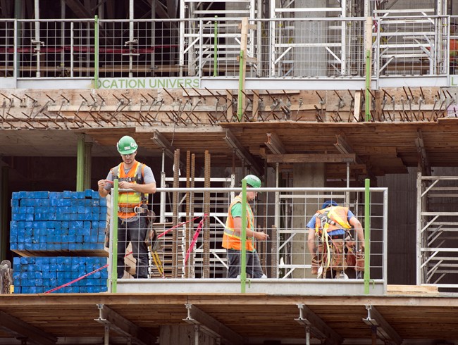 File photo: Construction workers are picture in Montreal on July 2, 2013.