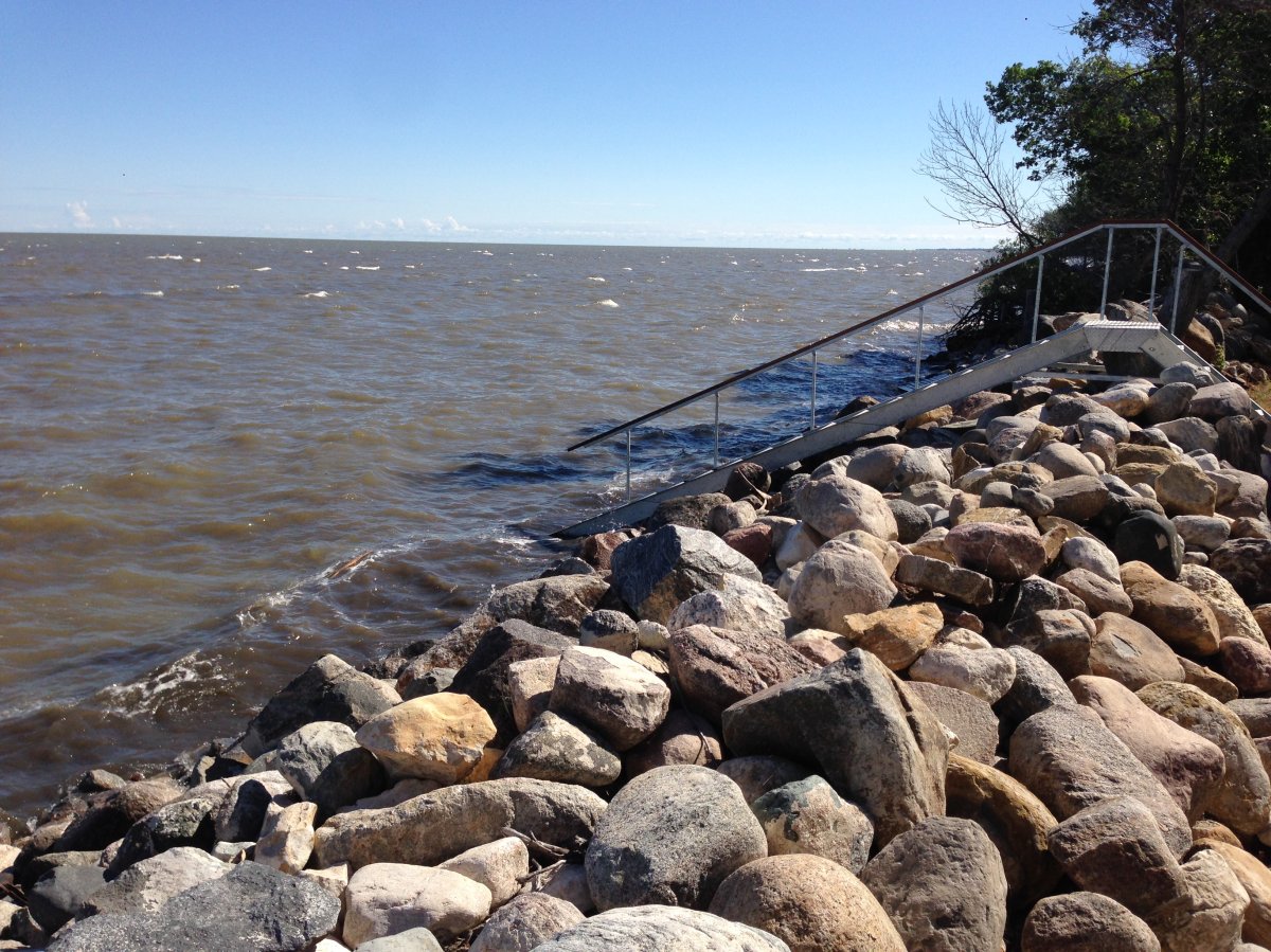 Water rises against rocks placed to hold back waves at Delta Beach on Lake Manitoba in July.