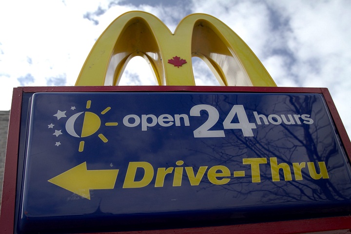 A 24-hour drive-thru sign outside a McDonald's restaurant.