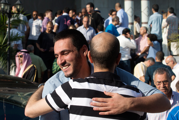 Muslims celebrate after a prayer session marking Eid al-Fitr the end of the Muslim holy fasting month of Ramadan at the Mosque and Islamic Cultural Center in Madrid, Monday, July 28, 2014.