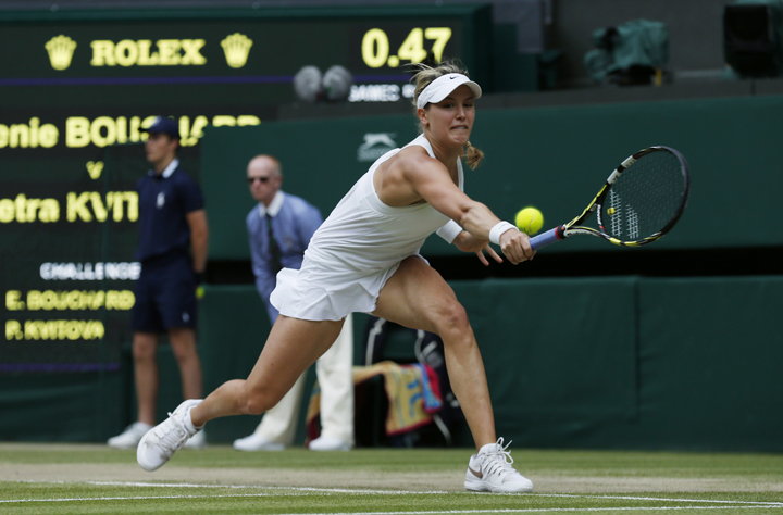 Eugenie Bouchard plays a return to Petra Kvitova during the women's singles final match at the All England Lawn Tennis Championships in Wimbledon, London, Saturday, July 5, 2014. 