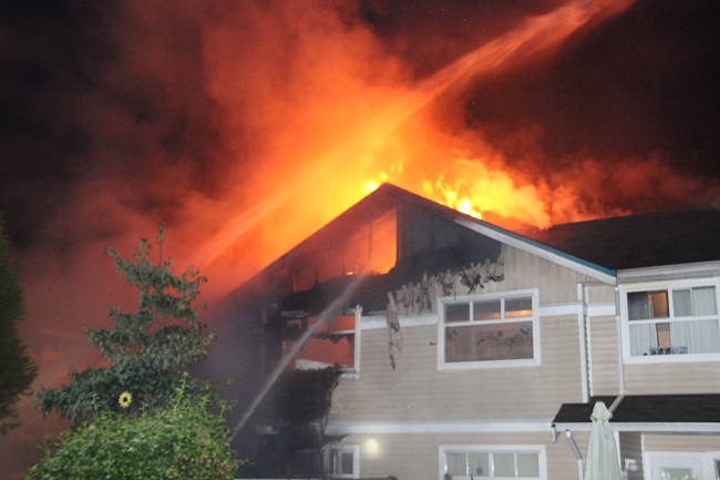 Fire crews battle housing co-op fire in Surrey - image
