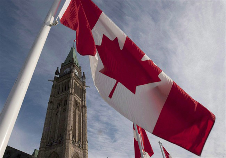 A Canadian flag flies on under the Peace Tower ahead of the resumption of parliament in Ottawa.