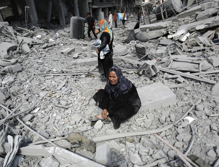 A Palestinian woman reacts at seeing destroyed homes in the northern district of Beit Hanun in the Gaza Strip.