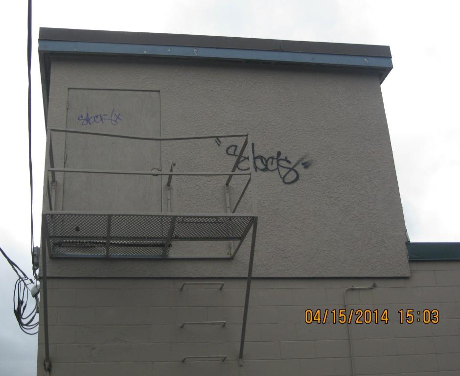 Graffiti with the word 'STOCK' on a building.