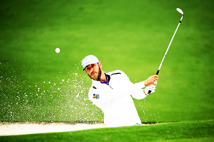 Graham DeLaet of Canada plays a bunker shot during a practice round prior to the start of the 2014 Masters Tournament at Augusta National Golf Club on April 8, 2014.