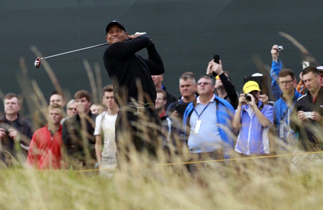 Tiger Woods plays a shot off the 5th tee during a practice round ahead of the British Open Golf championship at the Royal Liverpool golf club, Hoylake, England, Tuesday July 15, 2014. 