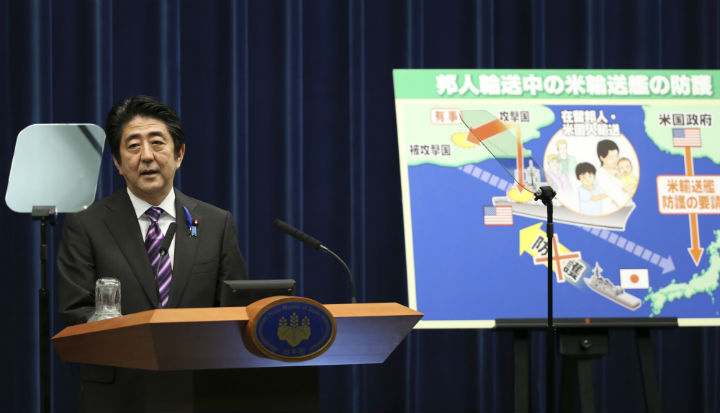 Japanese Prime Minister announces a reinterpretation of Article 9 of the postwar constitution