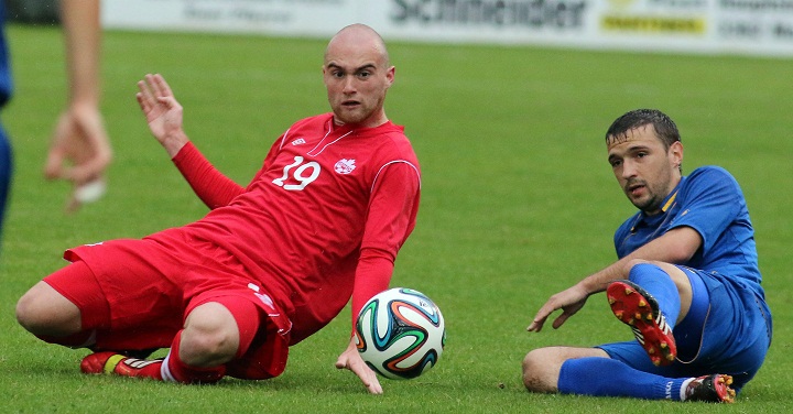 Canada's Jeremy Gagnon-Lapare challenges for a ball with Artur Patras of Moldova on May 27, 2014.