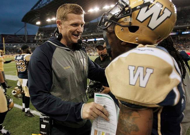 Winnipeg Blue Bombers head coach Mike O'Shea congratulates Demond Washington for his fumble recovery touchdown against the Toronto Argonauts in Winnipeg last week.