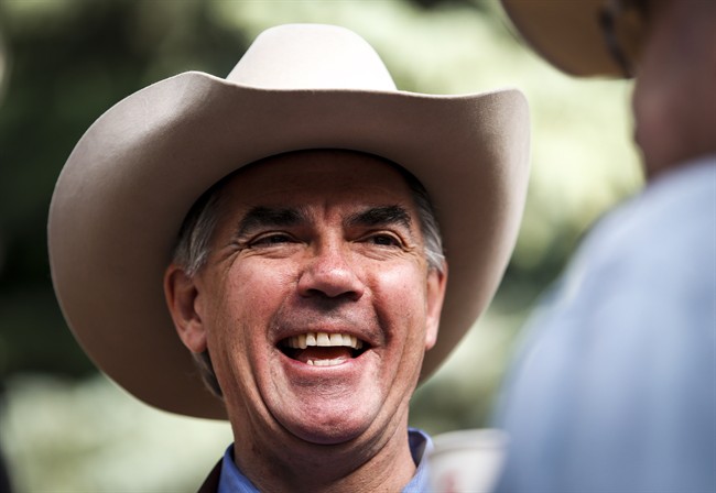 Alberta PC Party leadership candidate Jim Prentice talks with constituents at a Stampede breakfast in Calgary, Alta., Monday, July 7, 2014. THE CANADIAN PRESS/Jeff McIntosh.