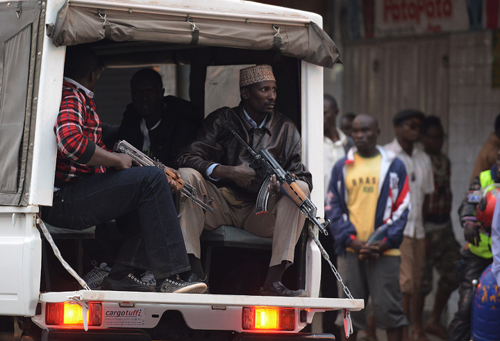 enya plain clothes police ride a truck patrolling the capital city as part of security measures during the rally for the opposition Coalition for Reforms and Democracy (CORD)on July 7, 2014 in Nairobi.