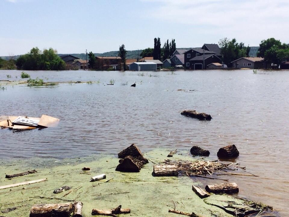 Debris floats atop the flood waters at Crooked Lake.