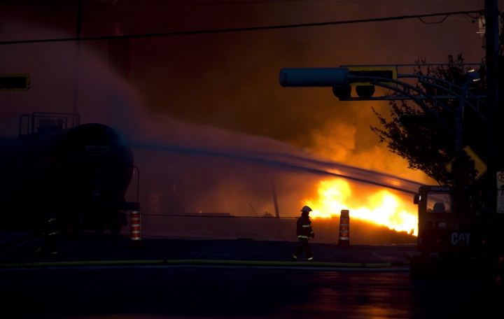 Fire keeps burning nearly 24 hours after railway cars that were carrying crude oil derailed in downtown Lac-Mégantic, Que., Saturday, July 6, 2013.
