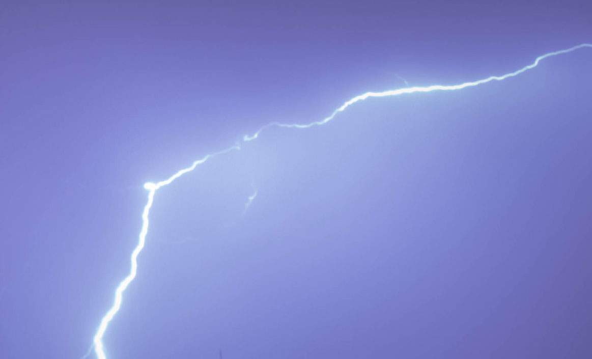 Lightning streaks across the sky during a thunderstorm.
